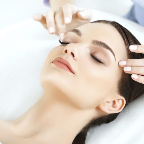 Face Massage. Close-up of a Young Woman Getting Spa Treatment.